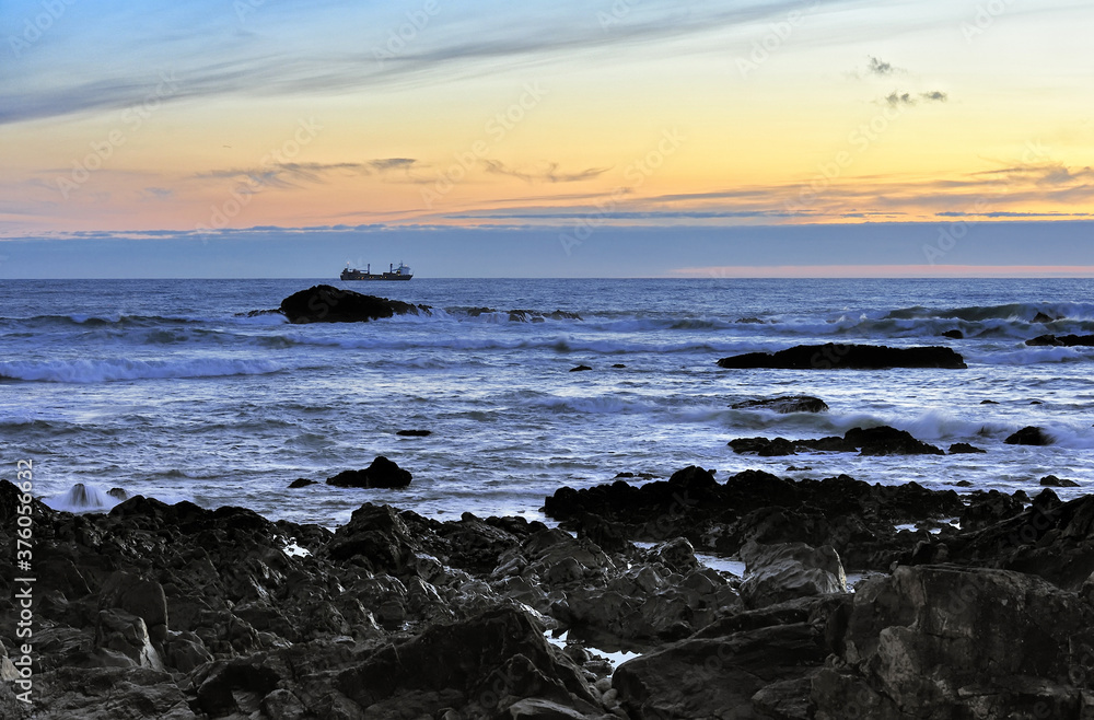 ship near the coast of the ocean in the evening