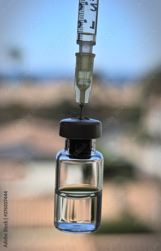 Vaccine bottle and syringe with injection fluid and aluminium
