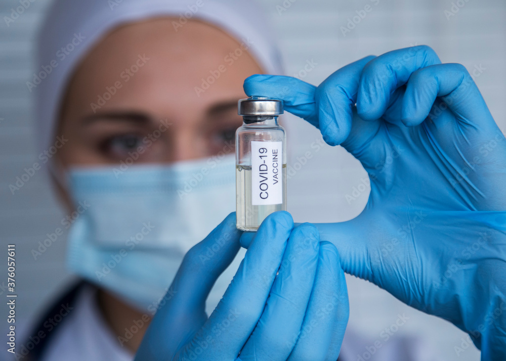 female doctor is holding syringe and vaccine for vaccination female doctor is holding syringe and vaccine for vaccination