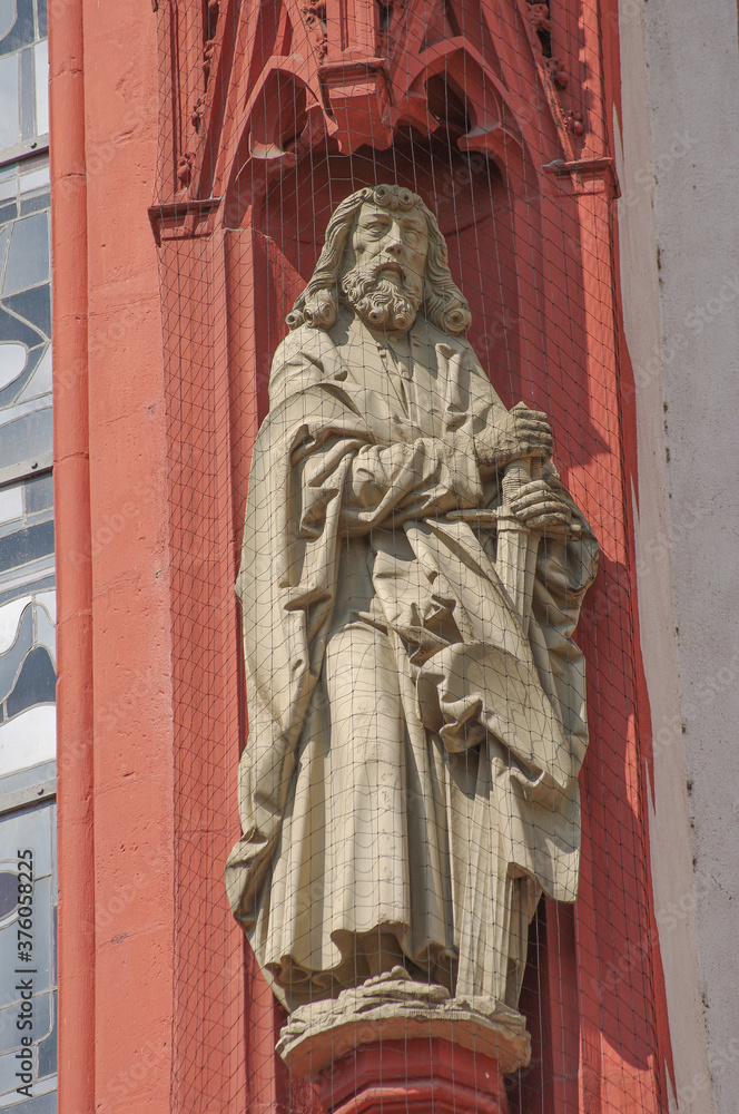 Ancient wall sculpture of a monk at the main facade of Mary chapel in historical downtown of Wurzburg, Germany