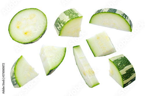 Zucchini slices isolated on a white background, top view. Sliced zucchini, courgette isolated on white. Pieces of zucchini, top view. Diced zucchini, closeup. Set of pieces of courgette.