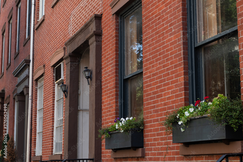 Beautiful Brick Residential Building Exterior with Windows and Flowers in New York City
