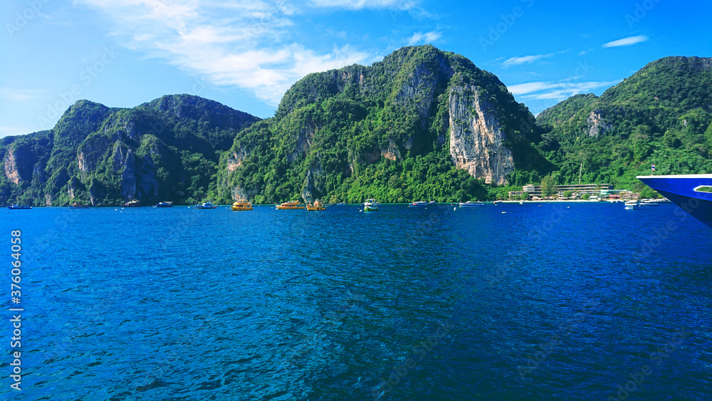 Beautiful view on the mountains and sea in the Phi Phi Don island near Phuket Island in Thailand. In the distance you can see jungle on the mountains and blue water.