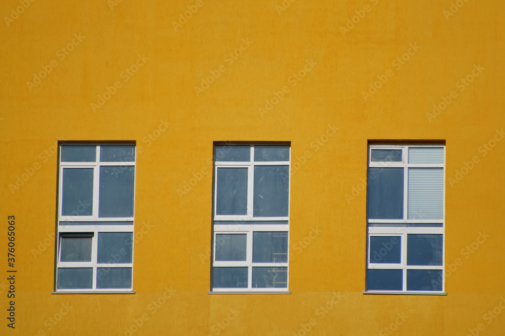 three Windows in the yellow wall