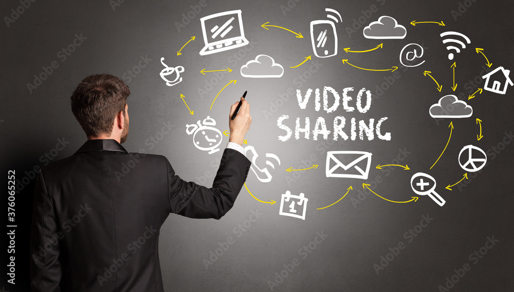 businessman drawing social media icons with VIDEO SHARING inscription, new media concept businessman drawing social media icons with VIDEO SHARING inscription, new media concept