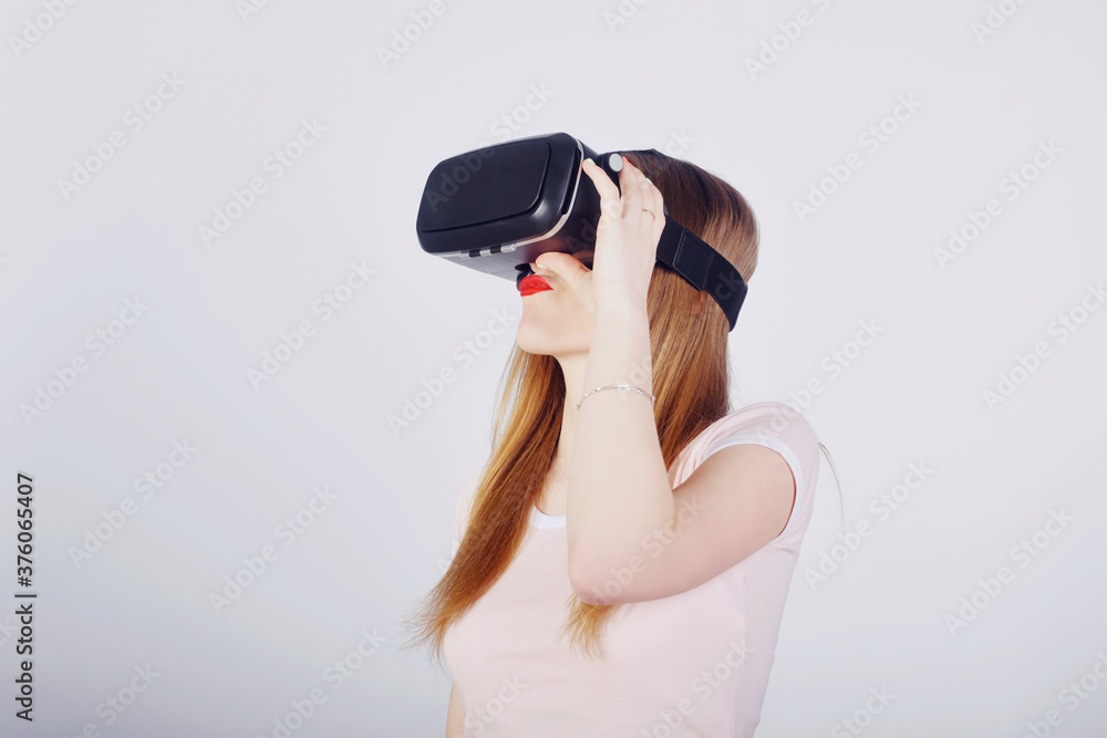 Girl on a white background plays virtual reality. Games and films vr. Emotions Girl on a white background plays virtual reality. Games and films vr. Emotions