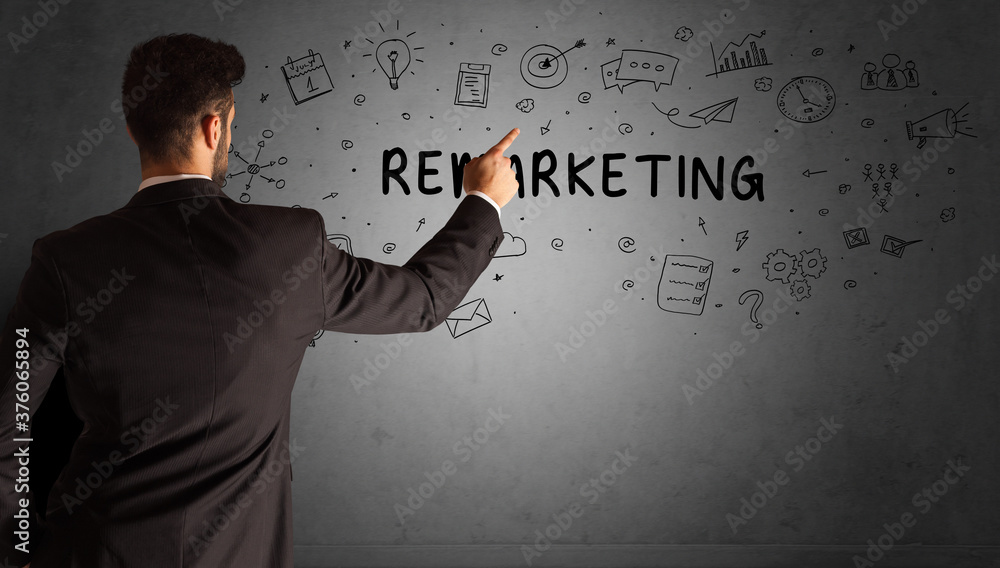 businessman drawing a creative idea sketch with REMARKETING inscription, business strategy concept businessman drawing a creative idea sketch with REMARKETING inscription, business strategy concept
