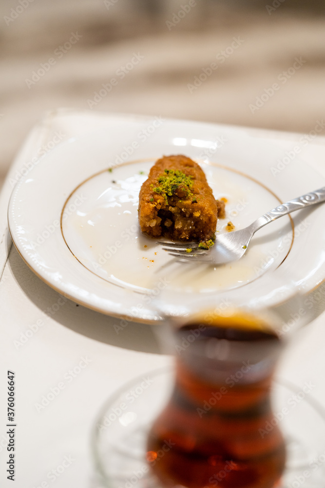 Turkish Dessert Kalburabasti / Sekerpare with Traditional Tea. Turkish Dessert Kalburabasti / Sekerpare with Traditional Tea.