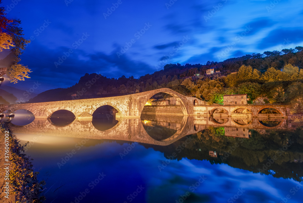 Devils Bridge, ancient medieval construction near Lucca, Italy. View at sunset