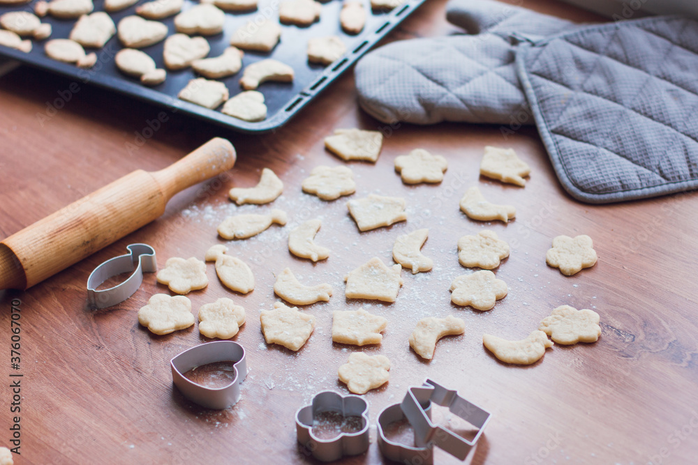 Cooking homemade cookies, dough and cookie cutters. Home-made food concept, insulation and new year's baking Cooking homemade cookies, dough and cookie cutters. Home-made food concept, insulation and new year's baking
