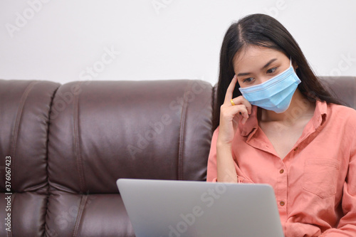 woman learning online at home with mask.