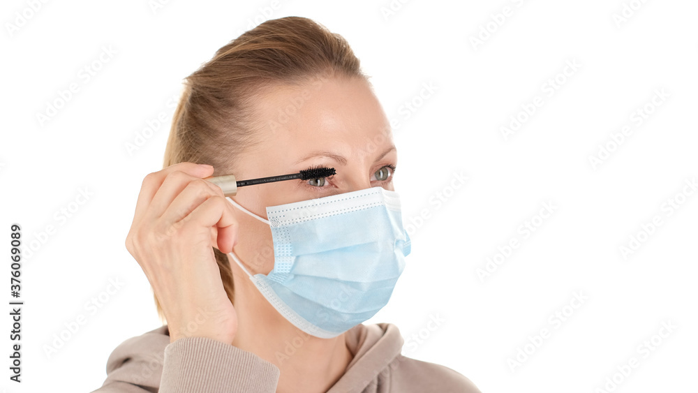 woman in protective mask paint eyelashes with mascara. corona virus prevention and makeup woman in protective mask paint eyelashes with mascara. corona virus prevention and makeup