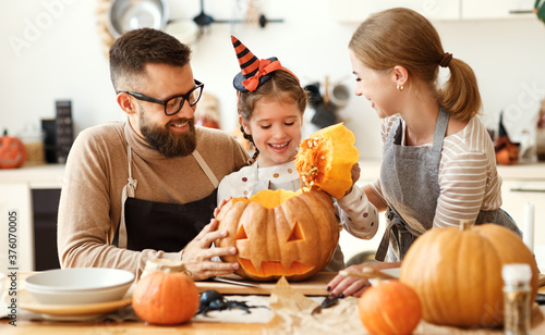 Happy family carving jack o lantern.