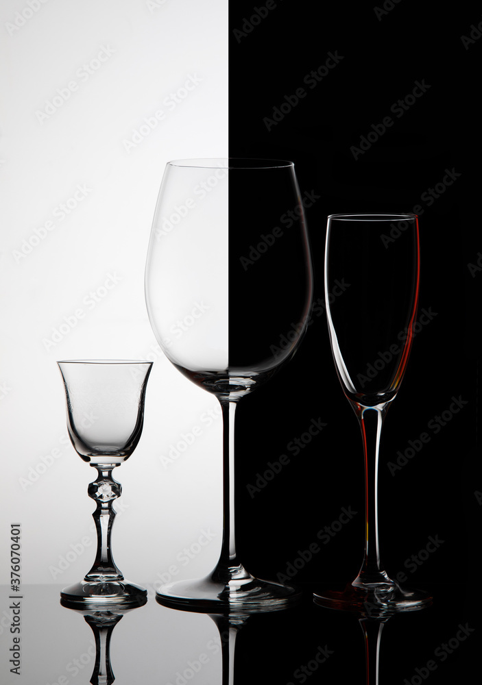 
Three glass goblets on black and white background