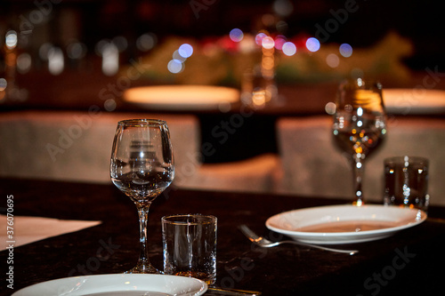 Restaurant table setting.  Glasses of champagne and empty plates on the banquet table. © SerJin