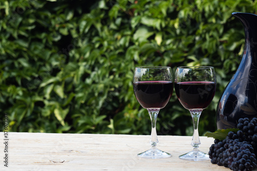  two glasses of red wine on blur green background