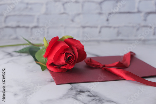 envelope and rose flower on white background 