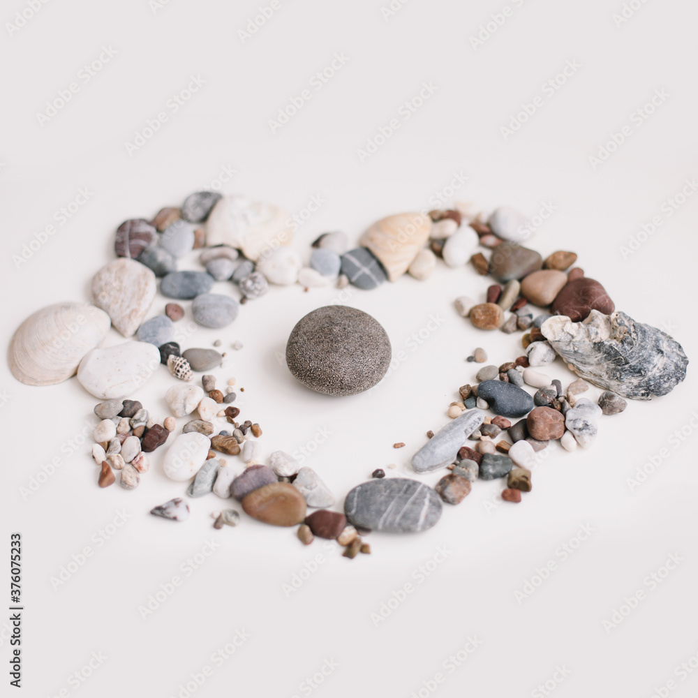 Fototapeta premium Soap with seashells and stones on a white background. Spa or wellness setting. Top view mockup