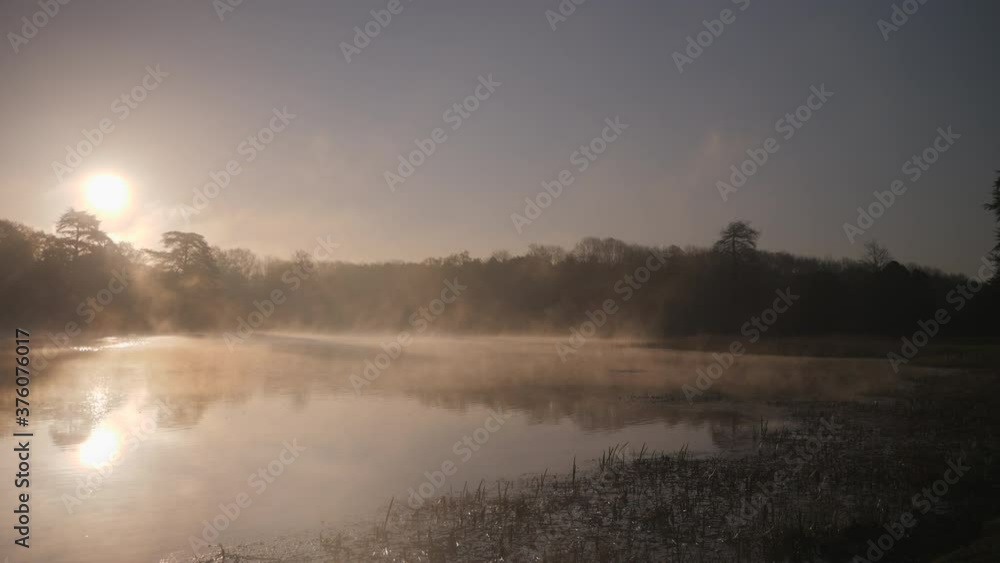 foggy morning by a lake at sunrise foggy morning by a lake at sunrise