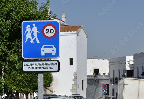 Traffic sign of pedestrian preference and speed limitation to 20 kilometers per hour in Spanish photo