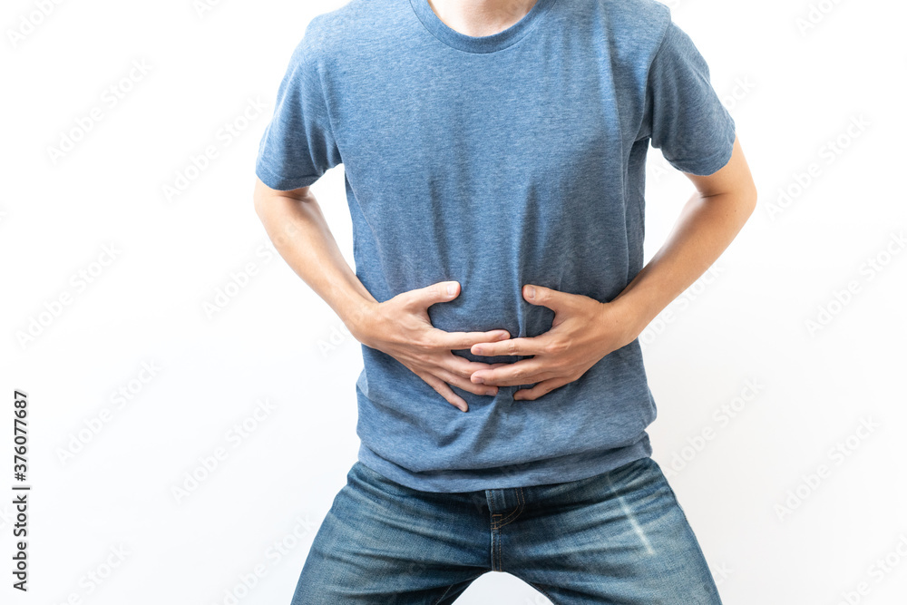 Φωτογραφία 腹痛　お腹を押さえる男性