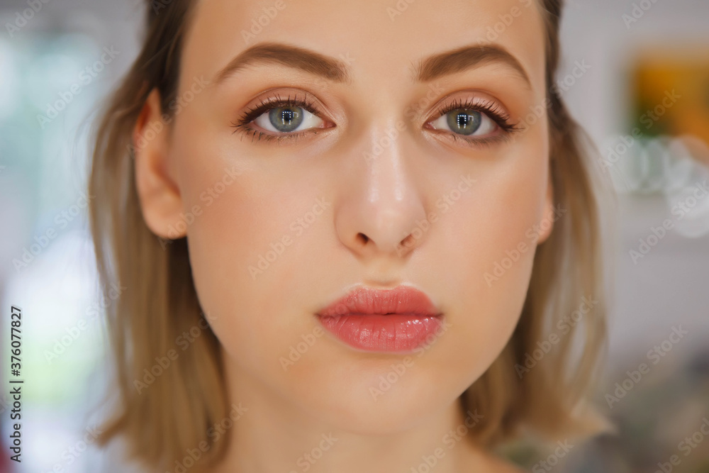 Beautiful young woman with perfect makeup. Close up of face of pretty model with natural makeup. Spa and beauty salon, skin care and healthy makeup. Copyspace. Concept of style, satisfaction beauty