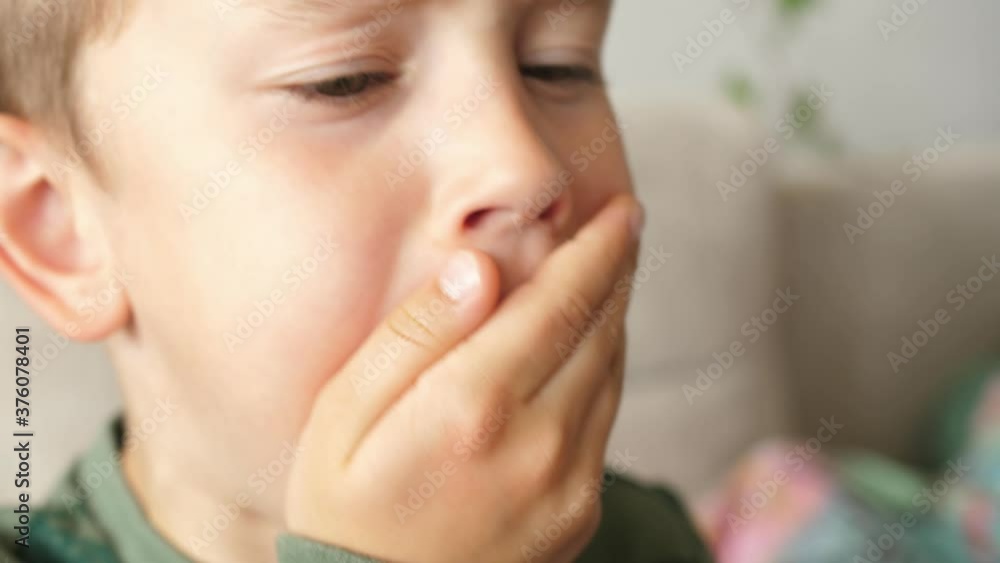 boy coughs coughing and covers his mouth with his hand boy coughs coughing and covers his mouth with his hand