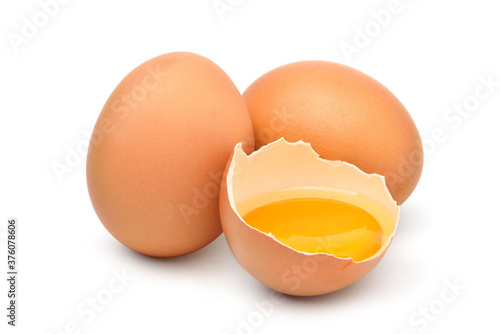 Chicken eggs and half with yolk isolated on a white background.