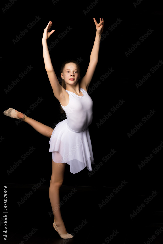 Full length portrait of a charming gymnast girl in elegant dress.