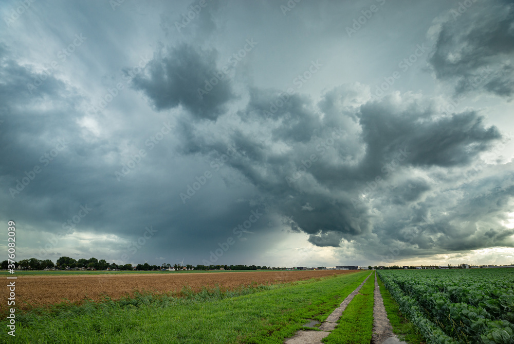 Wide angle view of a dramatic storm cloud over agricultural fields Wide angle view of a dramatic storm cloud over agricultural fields