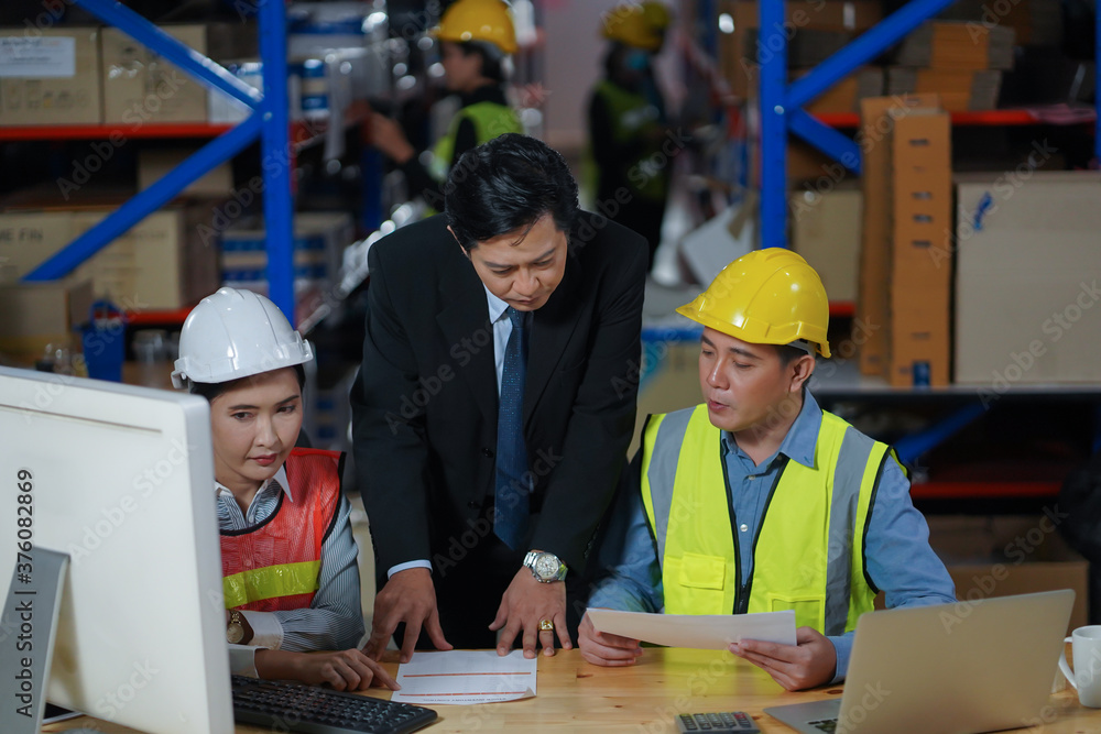 Manager with worker team working warehouse. During working hours in the warehouse, there is a checking, checking, stock for quality products, safe for customers. Women worker in warehouse concept. Manager with worker team working warehouse. During working hours in the warehouse, there is a checking, checking, stock for quality products, safe for customers. Women worker in warehouse concept.