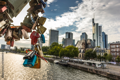 Frankfurt   Main  Germany - September 03rd 2020  A german photographer visiting the  Eiserner Steg  with its love locks. View along the river Main to the skyline of the financial district Frankfurt.