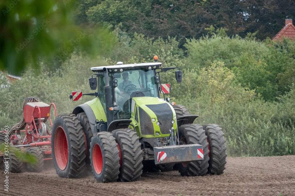 tractor brings new seeds into the soil tractor brings new seeds into the soil