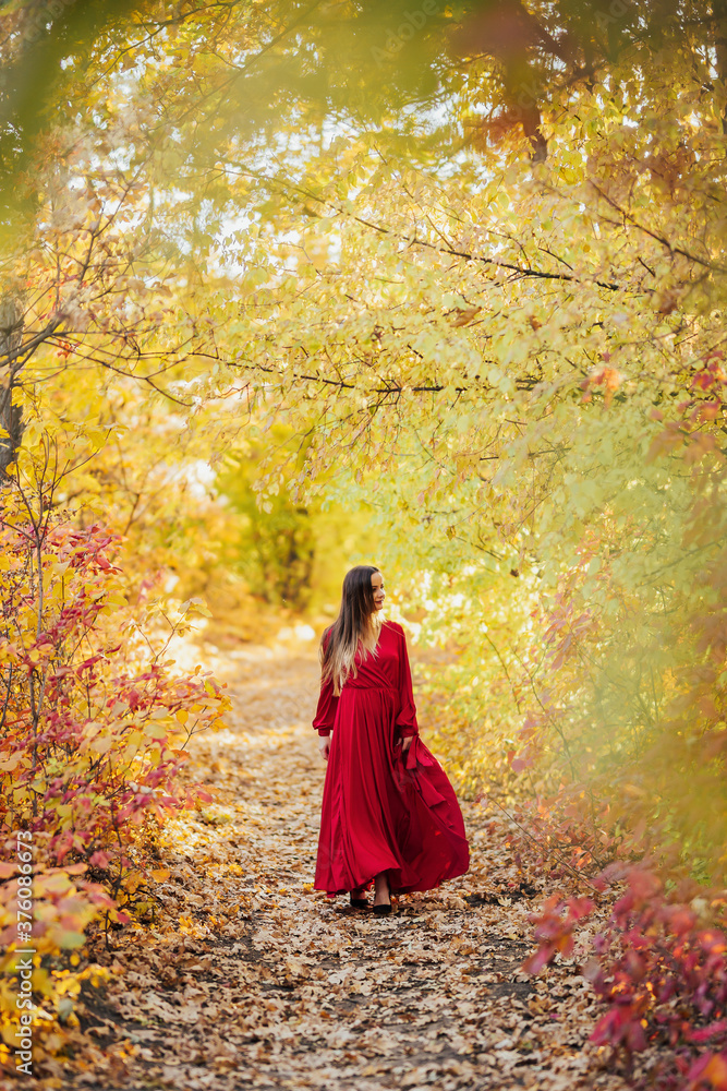 Autumn colorful nature. Happy girl walking in national park. 