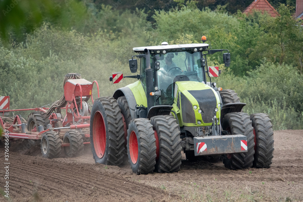 tractor brings new seeds into the soil tractor brings new seeds into the soil
