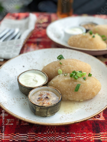 Potato stuffed dumplings servering in the plate photo