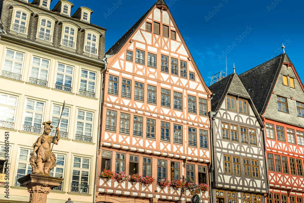 Frankfurt / Main, Germany - September 03rd 2020: A german photographer visiting the so called Römerplatz during a sunny day in summer. View the historical facades of the buildings.