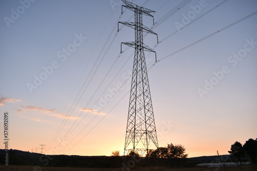 Power poles in the mountains at sunset