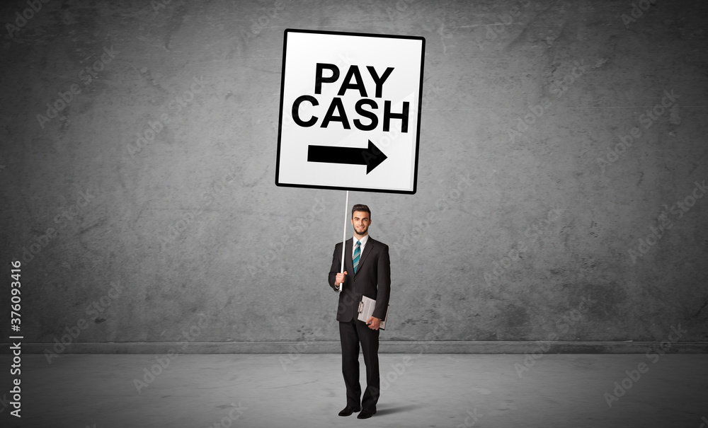 business person holding a traffic sign with PAY CASH inscription, new idea concept business person holding a traffic sign with PAY CASH inscription, new idea concept