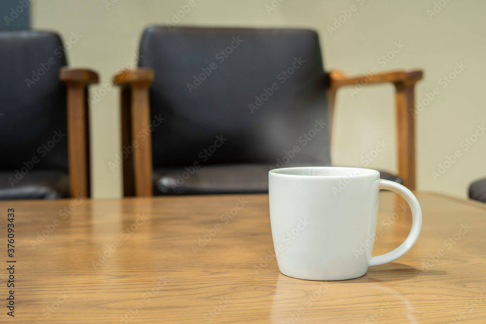 Hot coffee with smoke in the white cup on the table.day light in the moring. Hot coffee with smoke in the white cup on the table.day light in the moring.