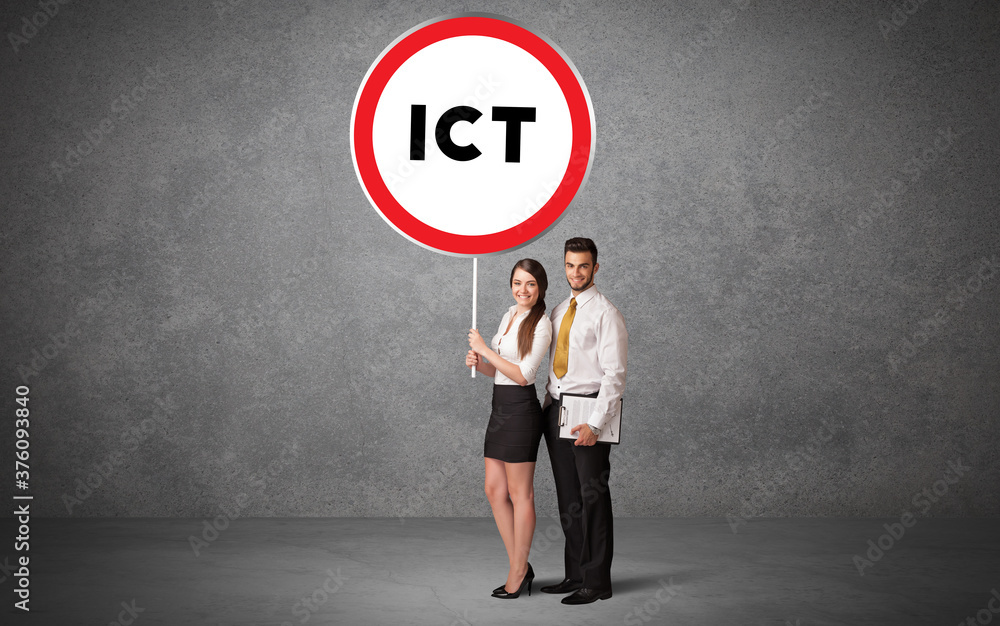 Young business person holdig traffic sign with ICT abbreviation, technology solution concept Young business person holdig traffic sign with ICT abbreviation, technology solution concept