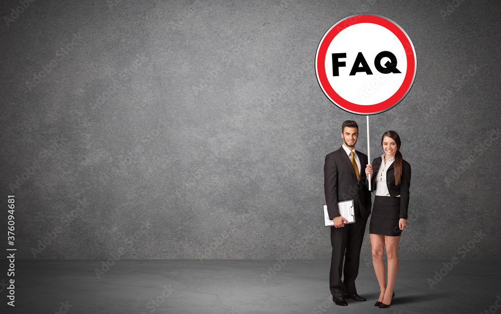 Young business person holdig traffic sign with FAQ abbreviation, technology solution concept Young business person holdig traffic sign with FAQ abbreviation, technology solution concept