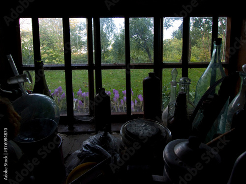old window in the dark with flasks on the windowsill