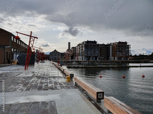 City pier in a renovated district on the cloudy day