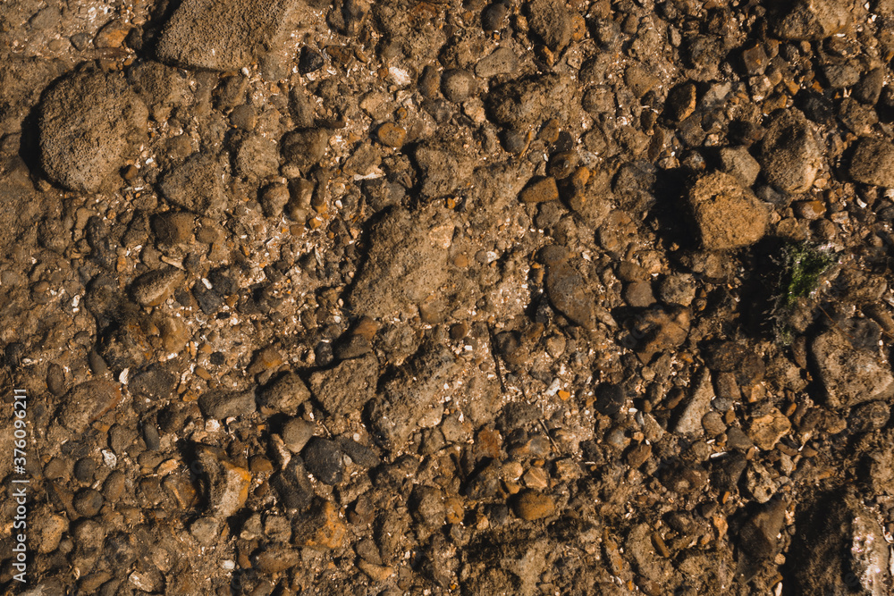 river coastline with stones of different sizes background river coastline with stones of different sizes background