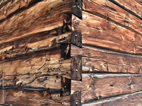 Bilde på lerret Old fashioned building exterior with rough wooden wall and dovetail corner detail