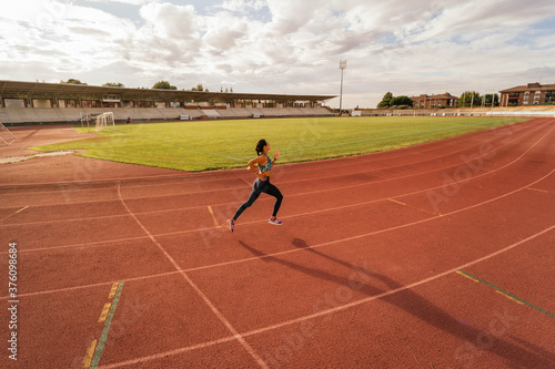 Young girl running on running track