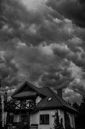
menacing and impressive storm clouds over the green, wild forest