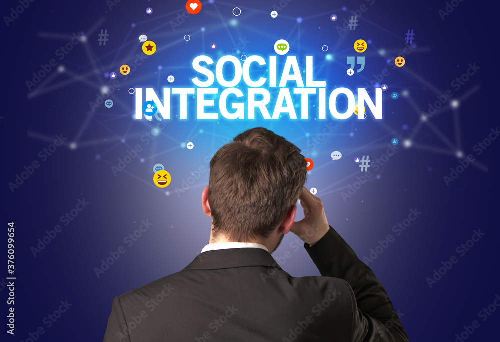 Rear view of a businessman with SOCIAL INTEGRATION inscription, social networking concept Rear view of a businessman with SOCIAL INTEGRATION inscription, social networking concept