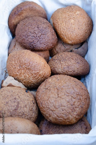 Lots of loaves of bread together. Brown bread background.
